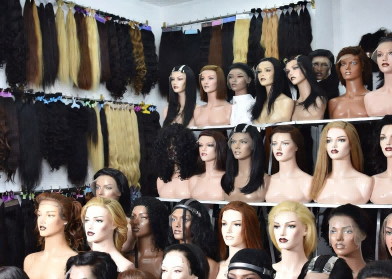 Diverse range of premium human hair wigs on display in a modern Qingdao wig factory Diverse range of premium human hair wigs on display in a modern Qingdao wig factory